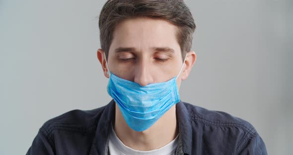 Portrait of Caucasian Millennial Man Teaches Showing Correct Wearing of Medical Mask Closeup Patient