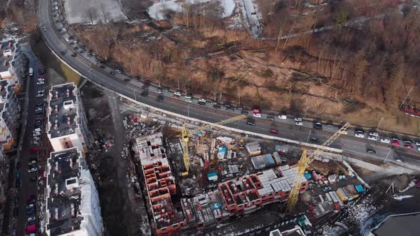 Aerial View Flying Above A Block Under Construction Next To The Highway