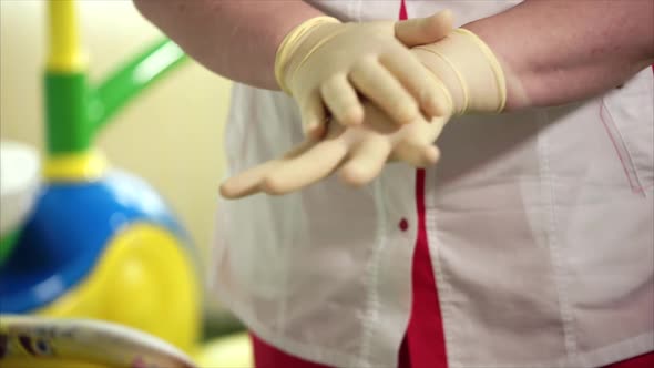 Close Up Shot of the Nurse's Hands Who Wears Latex Gloves Woman in a White Coat
