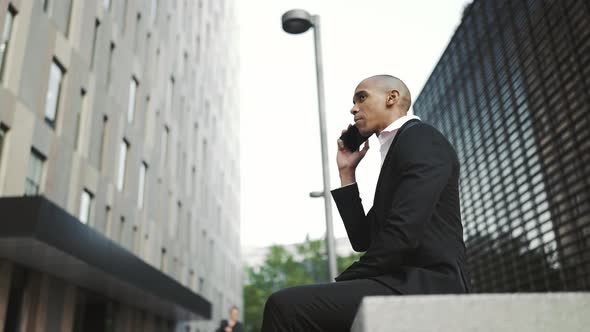 Smiling African businessman talking on mobile