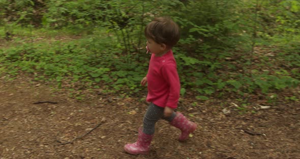 Back View of Little Girl Walking on Forest Path
