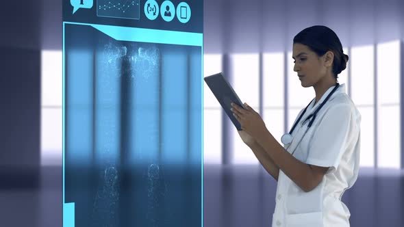 Doctor looking at digitally generated medical icons on tablet