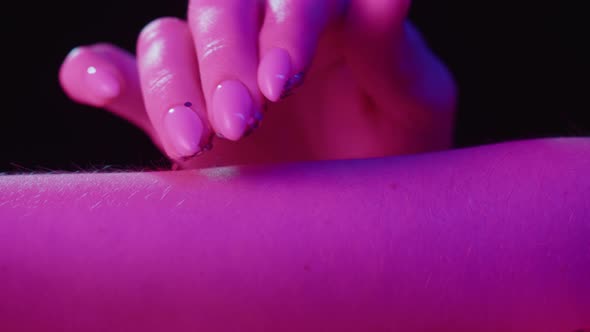 Hand Skin in Pink Neon Light Female Human Body Part and Ultraviolet Touching Arm Surface Macro