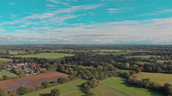 Pan around drone shot over the green English countryside fields