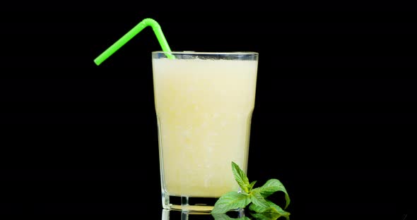 Melon Juice in a Glass with Tube Slowly Rotates