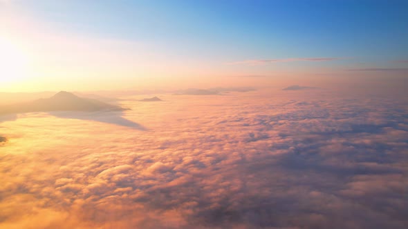 4K Drone Flying through the clouds at dusk or dawn. Aerial top cloudscape