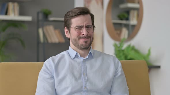 Portrait of Young Man Showing No Sign By Head Shake at Home