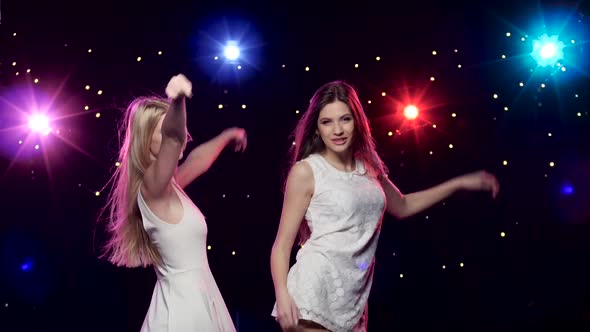 Sexy Woman Dancing Together in Front of Disco Style Lights