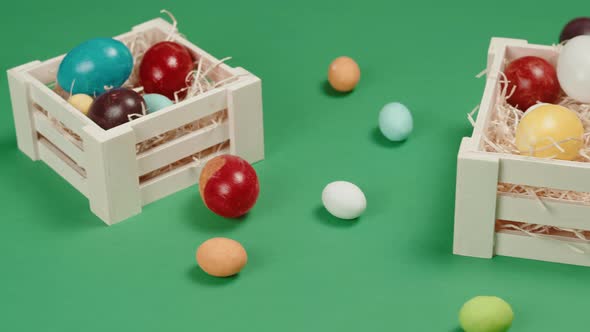 Easter Boxes with Colored Eggs and Green Background