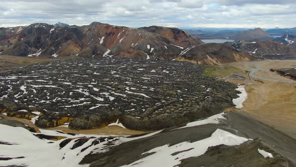 Drone over Laugahraun lava field and Landmannalaugar rainbow mountains, Iceland