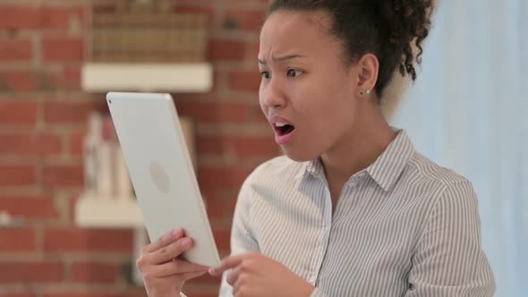 Portrait of African Woman Reacting to Loss on Tablet