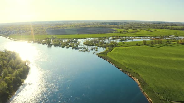 Aerial View Green Forest Woods And Curved River Landscape In Sunny Spring Day