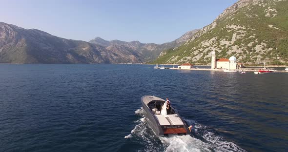 Motor Boat with Newlyweds Sails on the Sea to the Island of Gospa Od Skrpjela