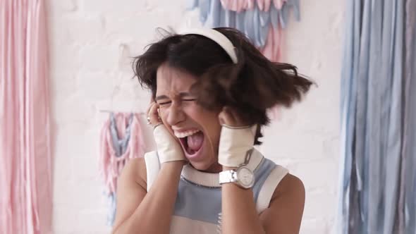 Brunette Girl Going Crazy While Listening to Music in Her Headphones