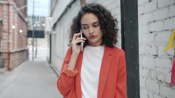 Portrait of Girl in Elegant Clothes Chatting on Mobile Phone Outdoors in City Street