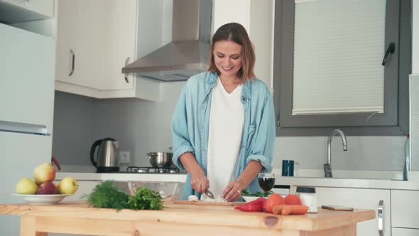 Young Pretty Caucasian Woman Cooking in Her Bright Kitchen