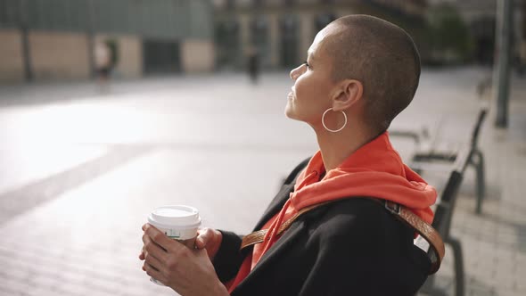 Meditative bald woman drinking coffee