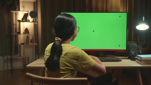 Asian Girl Student Distance Learning With Mock Up Computer Green Screen From Home
