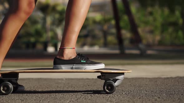 Close-up of the Foot Getting on the Skate Board and Pushing Off the Ground. Skate Board Goes on the