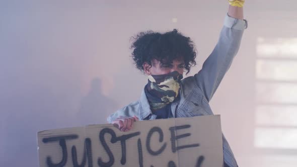 Diverse group of people wearing face masks holding protest signs raising fists