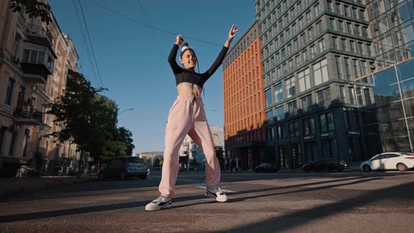 Stylish Hiphop Lady Dancer Performs Against City Buildings