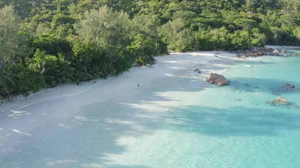 Aerial view of a person walking on the beach of Anse Lazio, Seychelles.