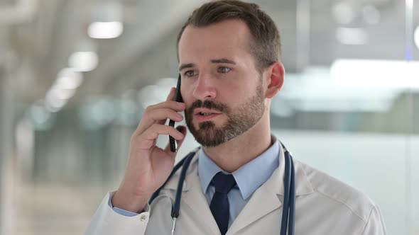 Portrait of Male Doctor Talking on Smartphone 