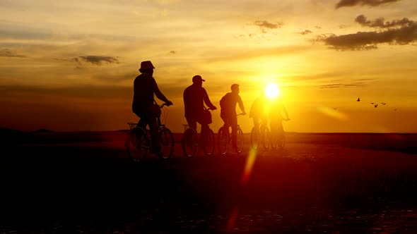 Cyclists Tour at Sunset Sky alt