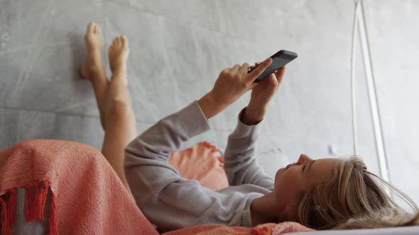 Caucasian woman sitting on couch in hotel room