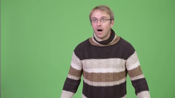 Studio Shot of Blonde Handsome Man Thinking While Looking Shocked