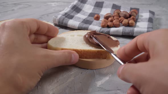 Spreads Chocolate Paste on Bread Closeup