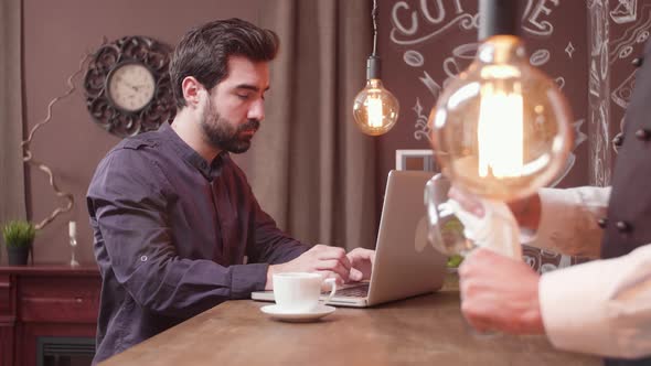 Young Freelancer Working Remotly From a Bar