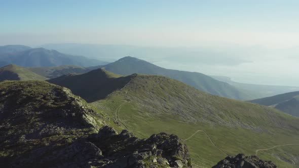 Drone Flying Over Textured Mountain Ranges