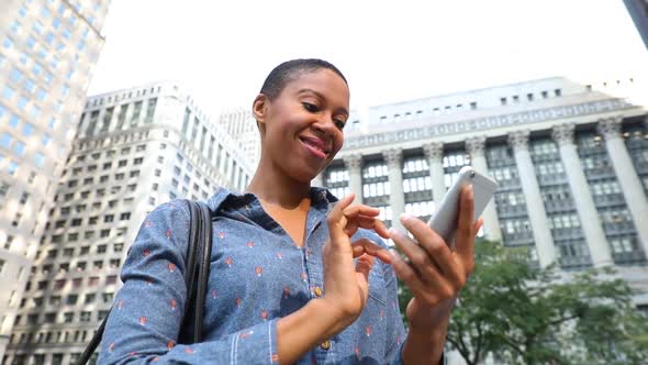 Black woman typing on the phone, slow motion