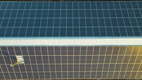 Blue photovoltaic solar panels mounted on building roof for producing clean ecological