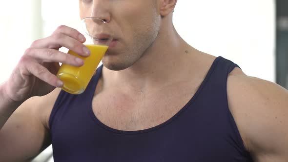 Sportsman Drinking Orange Juice, Refreshing Beverage After Intensive Training