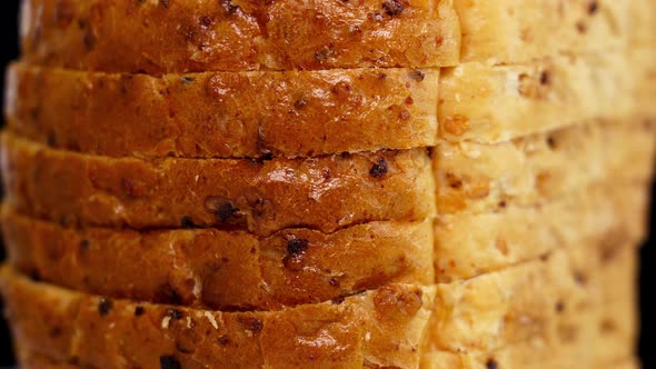 Stack of Bread Slices of Wheat Turns on Black Background