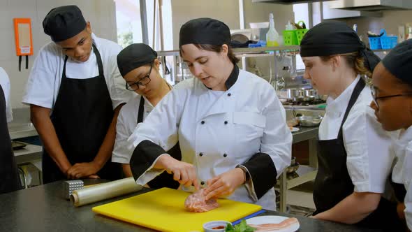 Chef cutting meat on chopping board in kitchen 4k