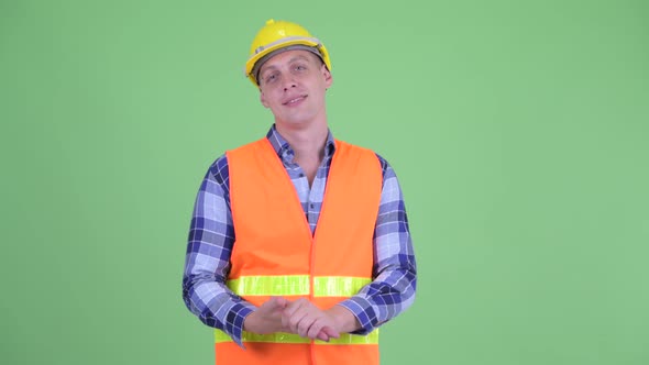 Happy Young Man Construction Worker Explaining Something