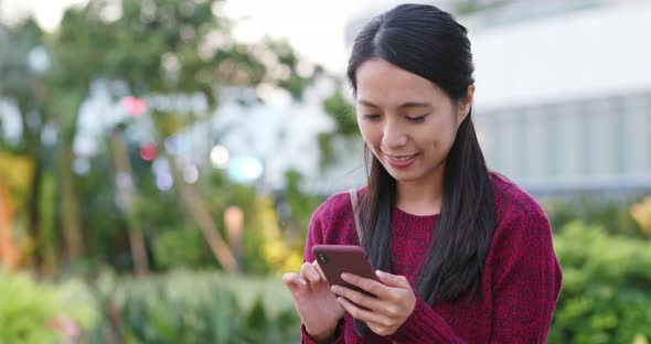 Woman use of mobile phone in city  park