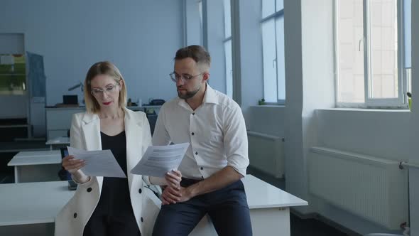 Woman Discuss Paper Work with Her Partner