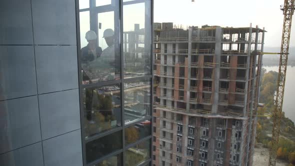 Designers Working By Window in Renovated Apartment