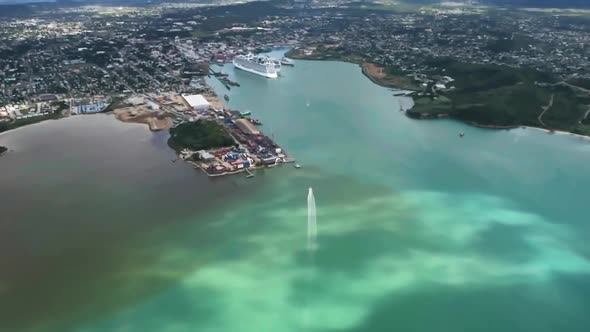 Drone shot of the city on island with boat and liner in harbor in Saint John's, Antigua and Barbuda