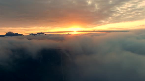 Flying with midnight sun above the clouds