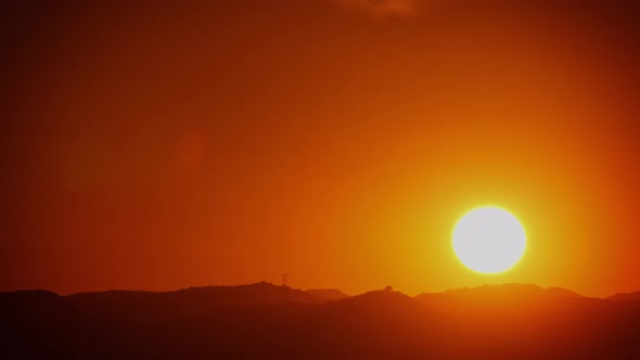 Time Lapse of the sun setting behind some mountains