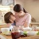 Happy Laughing Mother with Little Son Hugging on Kitchen After Cooking Dish - VideoHive Item for Sale
