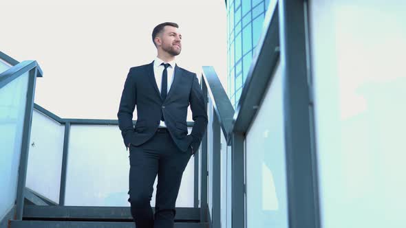 A Well Dressed Happy Bearded Office Corporate Male Executive Standing Outside a Modern Corporate