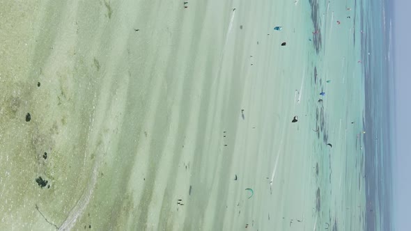 Zanzibar Tanzania  Vertical Video Kitesurfing Near the Shore of Ocean Slow Motion