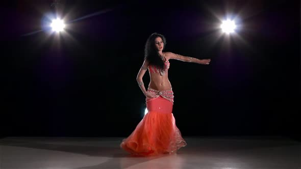 Attractive Belly Dance Woman Bellydancer Dancing on Black, Back Light, Slow Motion