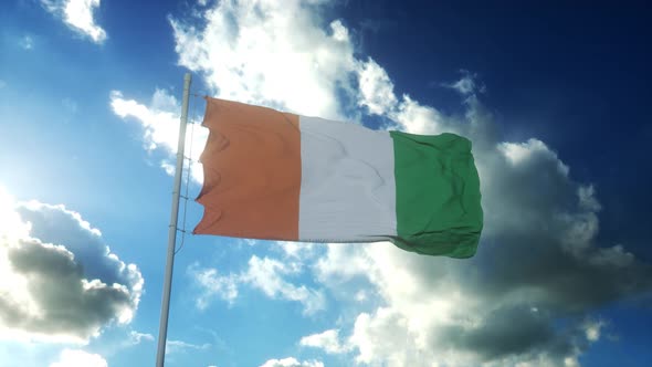 Flag of Ivory Coast Waving at Wind Against Beautiful Blue Sky